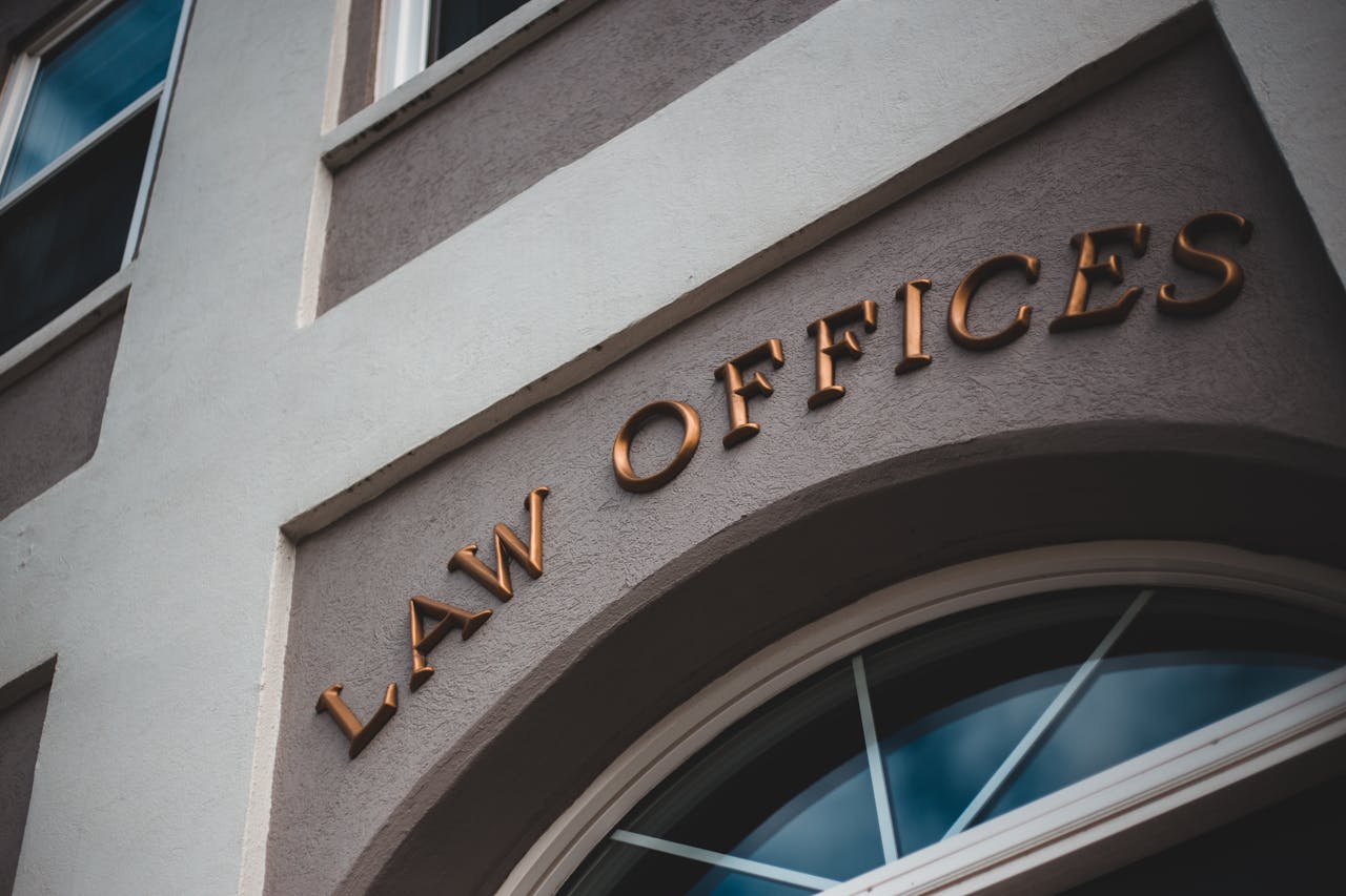 About Low angle view of a modern law office exterior with elegant facade and arched entrance.